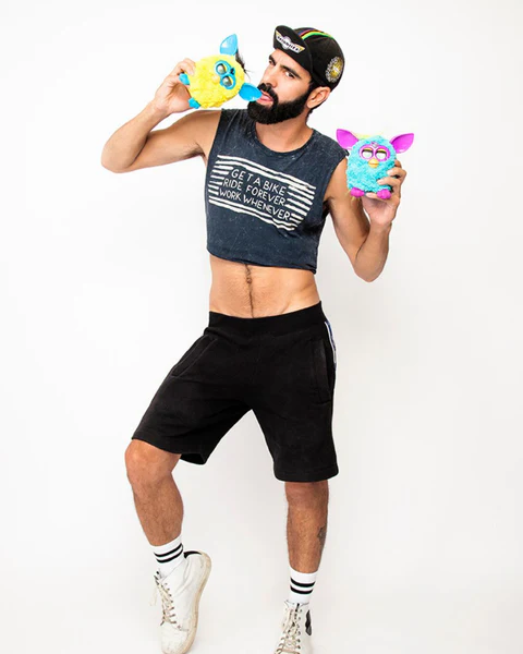 Bearded male figure posing with two Furby-like toys